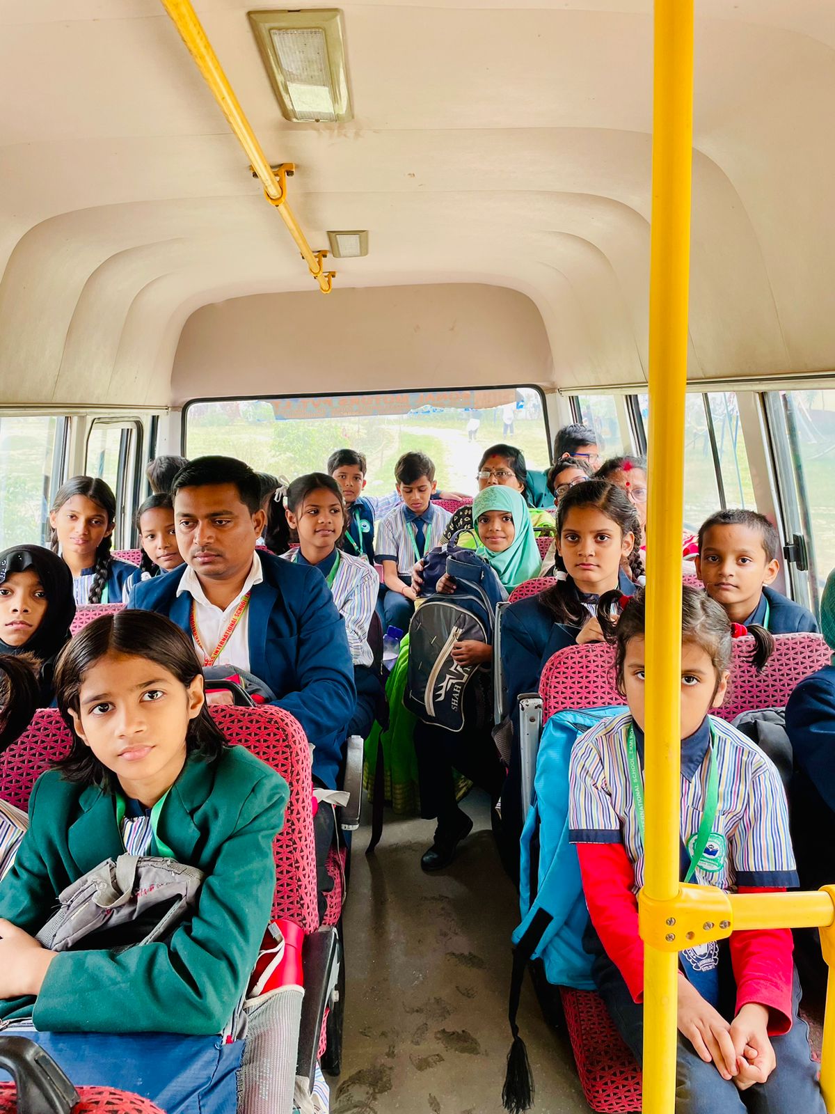 Bus supervisor assisting students