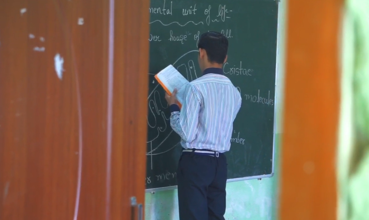 Teacher demonstrating a lesson on an interactive smart board