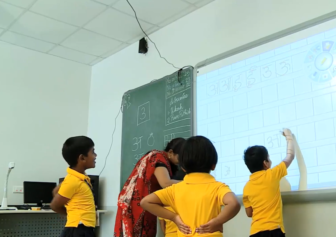 Students engaged in learning using a smart interactive whiteboard